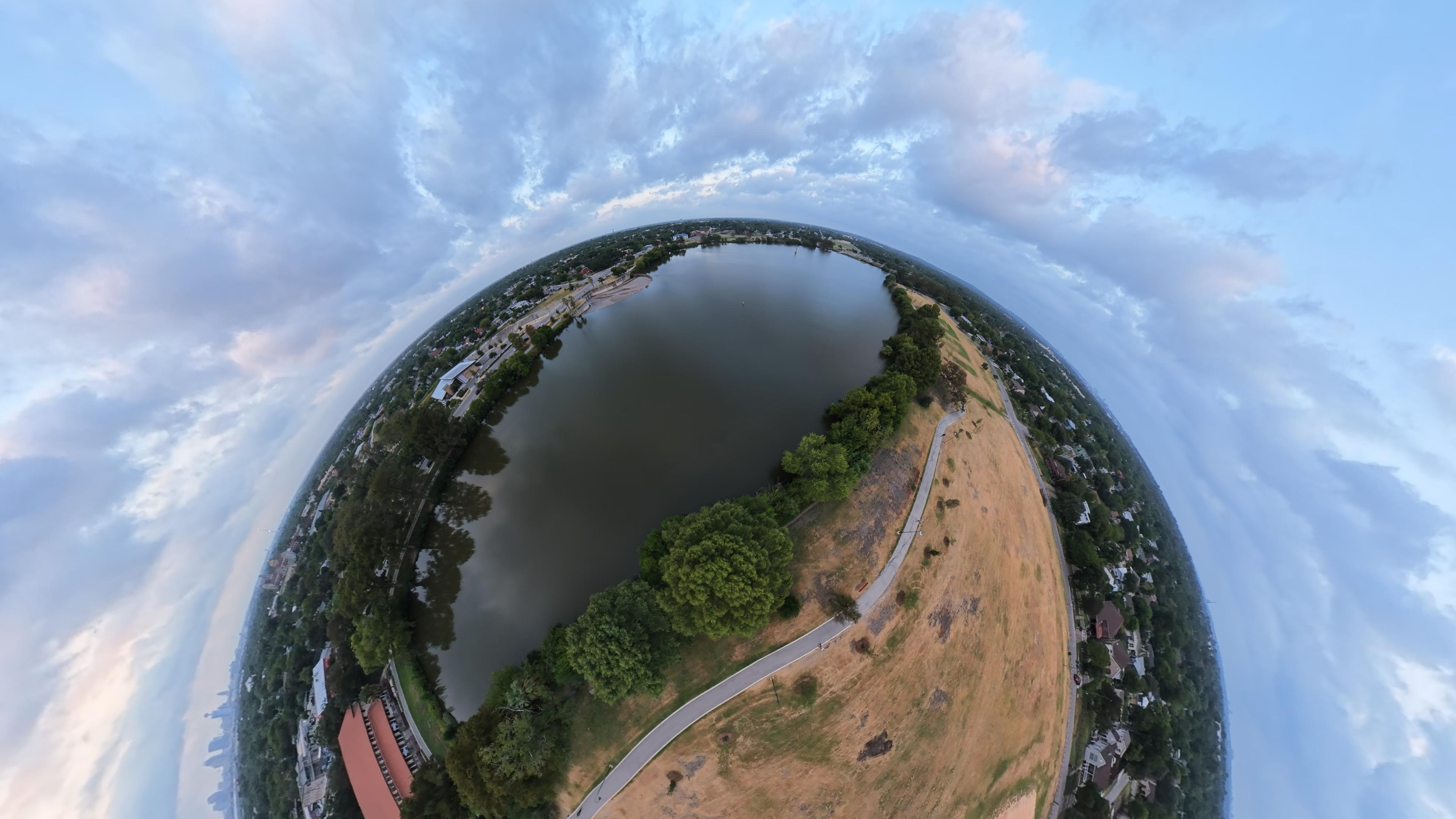 Panoramic aerial view of Woodlawn Lake, surrounding parkland and the San Antonio skyline
