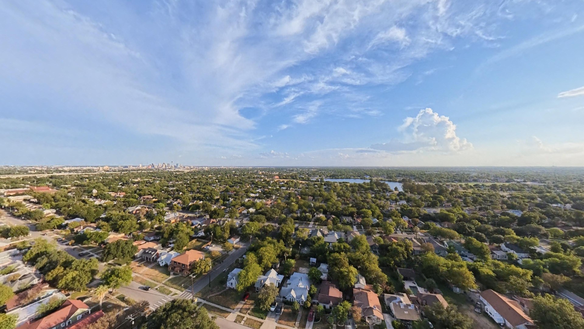 High aerial view over Mulberry and surrounding San Antonio streets, trees and distant skyline